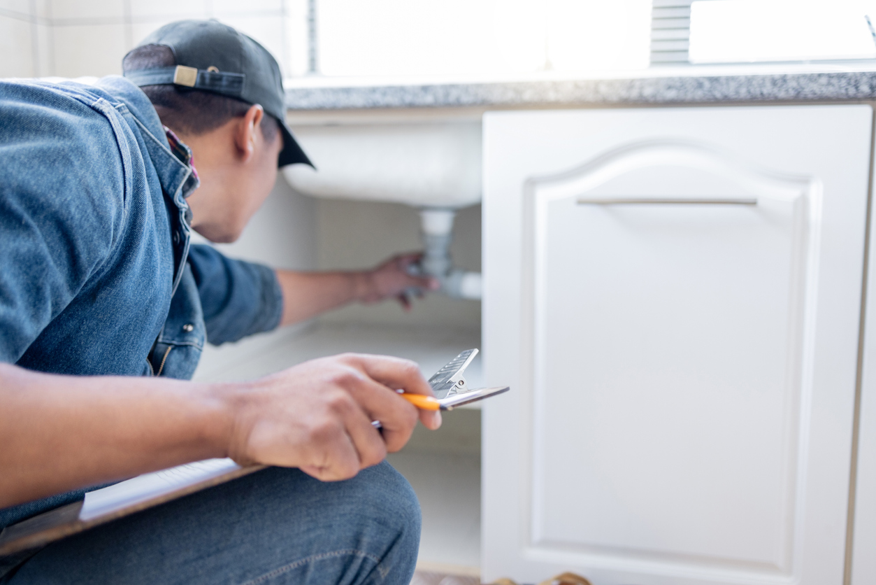 Plumber man fixing sink